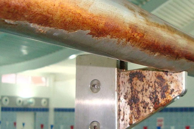 Rusty Metal Beam with Flaking Paint at Indoor Facility
