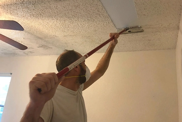Worker Removing Popcorn Ceiling with a Scraper, Painting Contractor San Jose