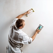 Worker Smoothing Wall Surface Preparing for Painting Contractor San Jose